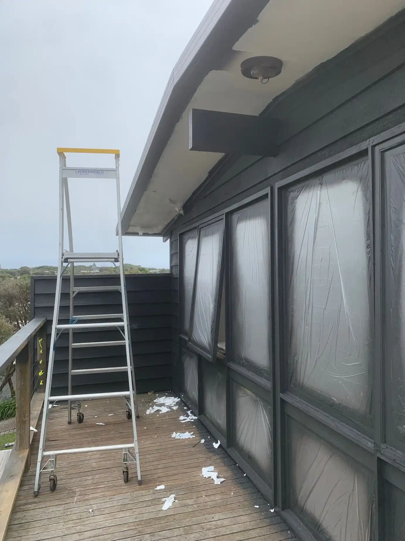 Residential exterior house painting project showing freshly painted walls with weather resistant finish.