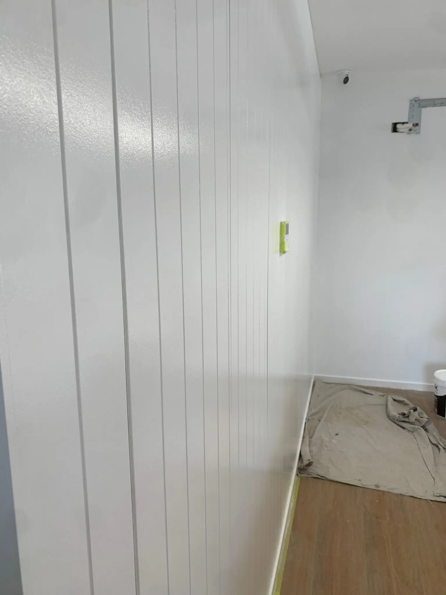 Interior house painting project with smooth wall finish in kitchen and living area.